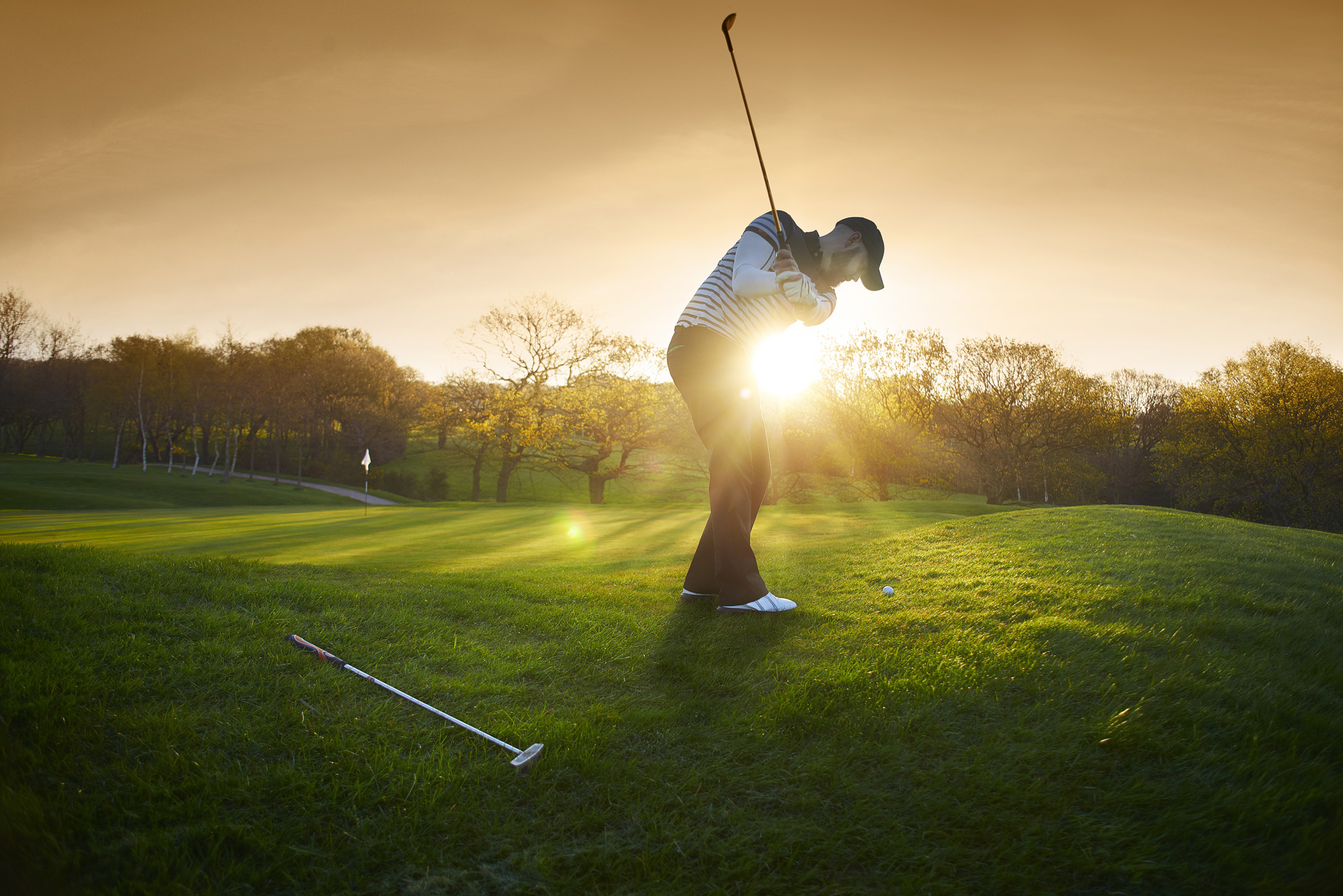 Golf swing at sunset 