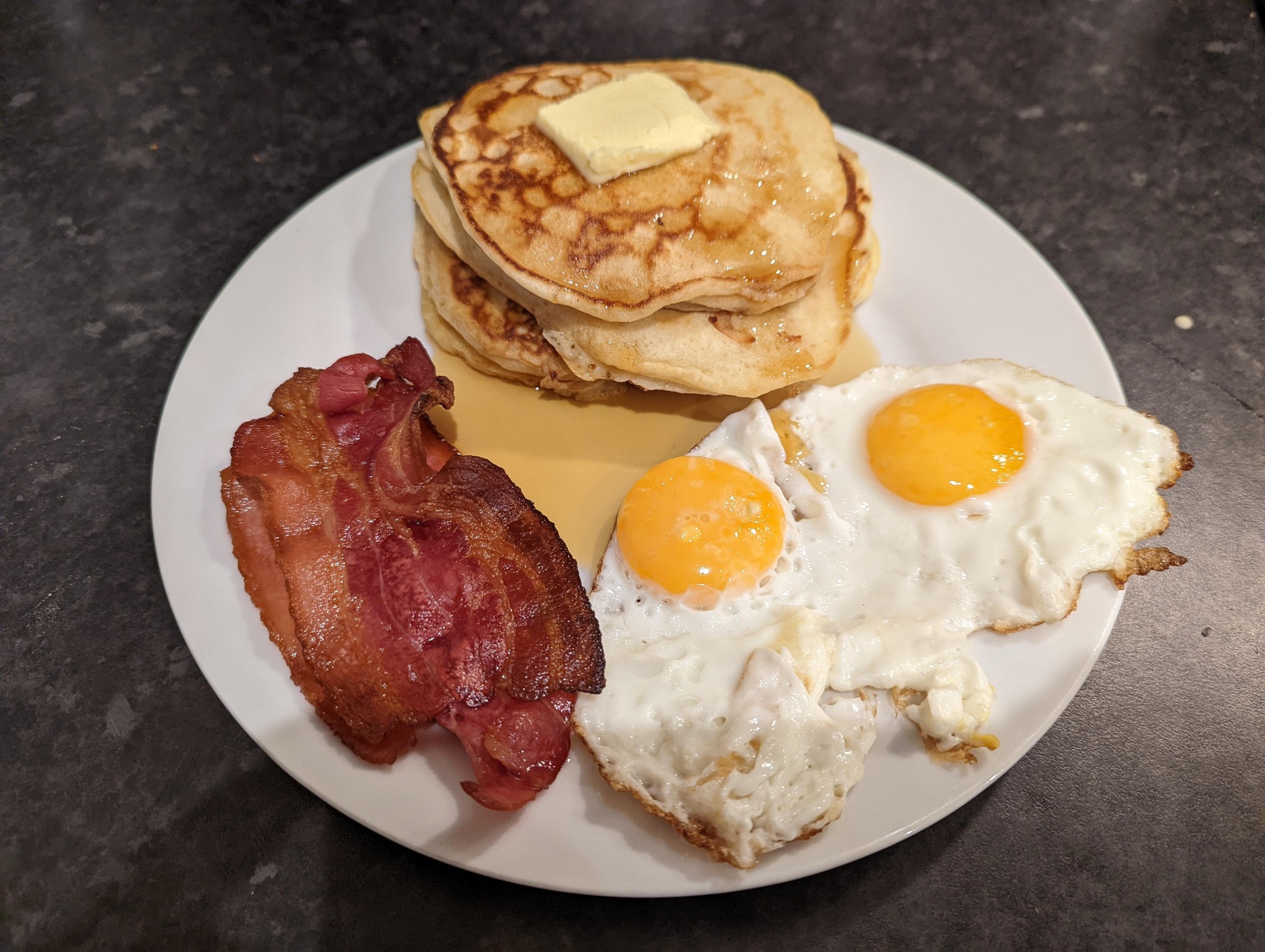 Bacon, eggs and pancakes on a plate