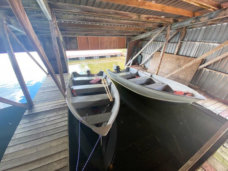 Two fishing boats inside a boat garage