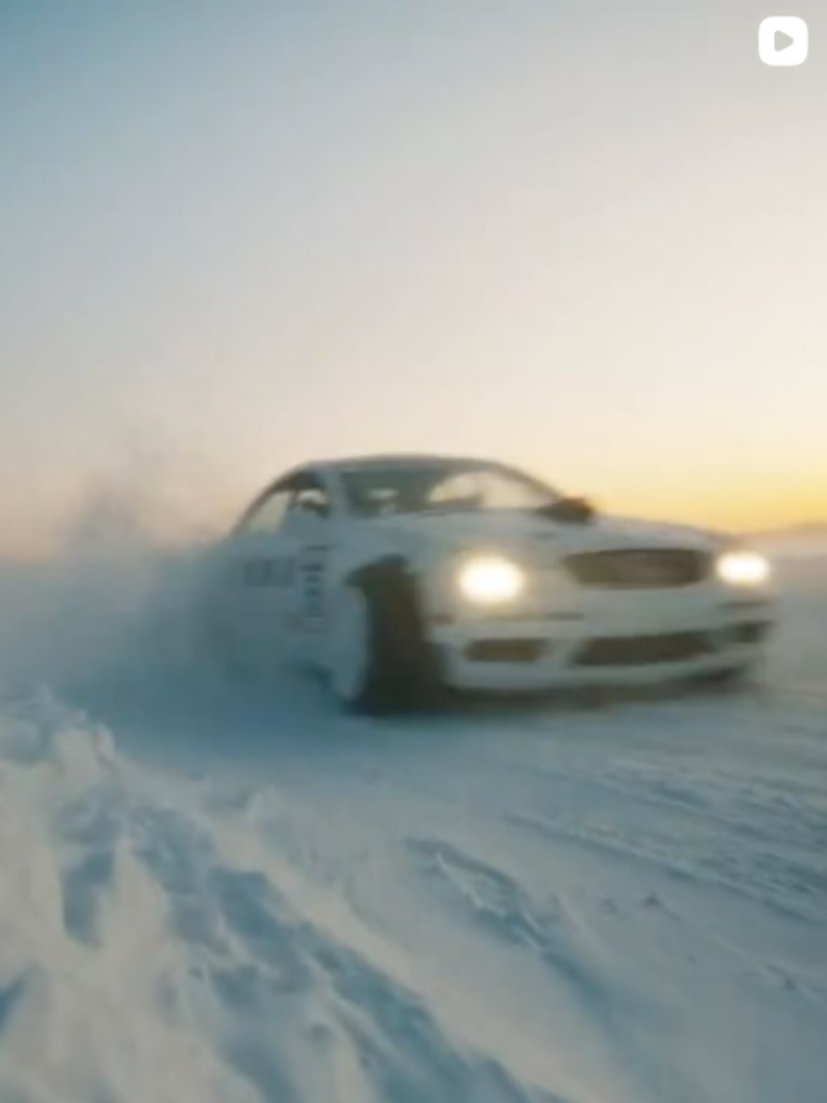 OVO Commercial. A white car driving on snow.
