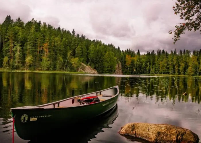 An empty canoe floating on a still lake