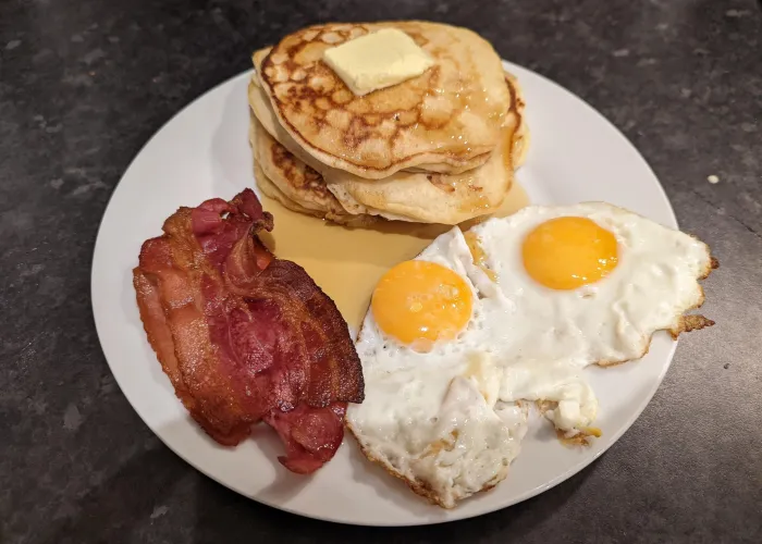 Bacon, eggs and pancakes on a plate