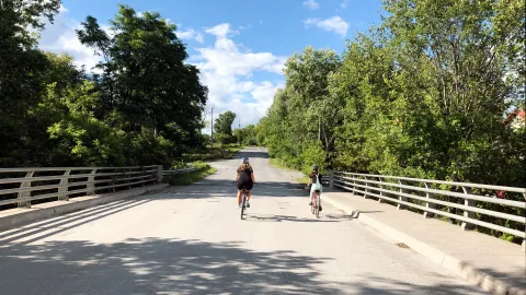 Cyclers in Hastings County crossing over a picturesque bridge