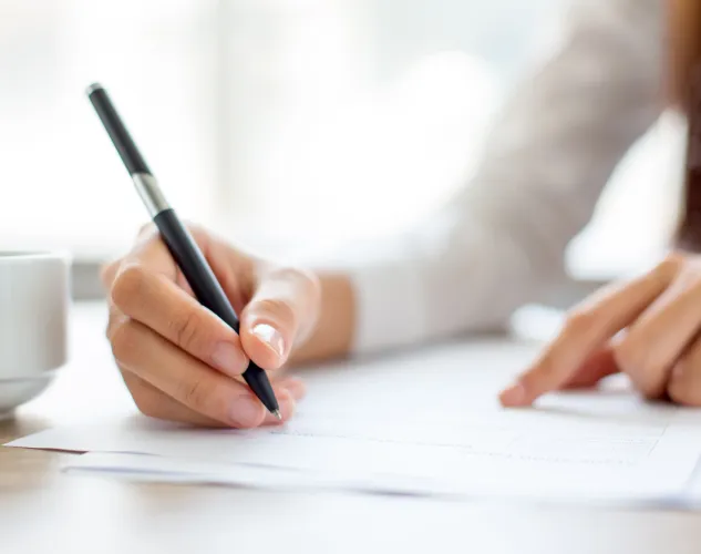 businesswoman-writing-paper-office